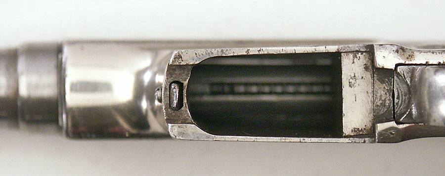  A spacer is inserted at the rear of the magazine well.
