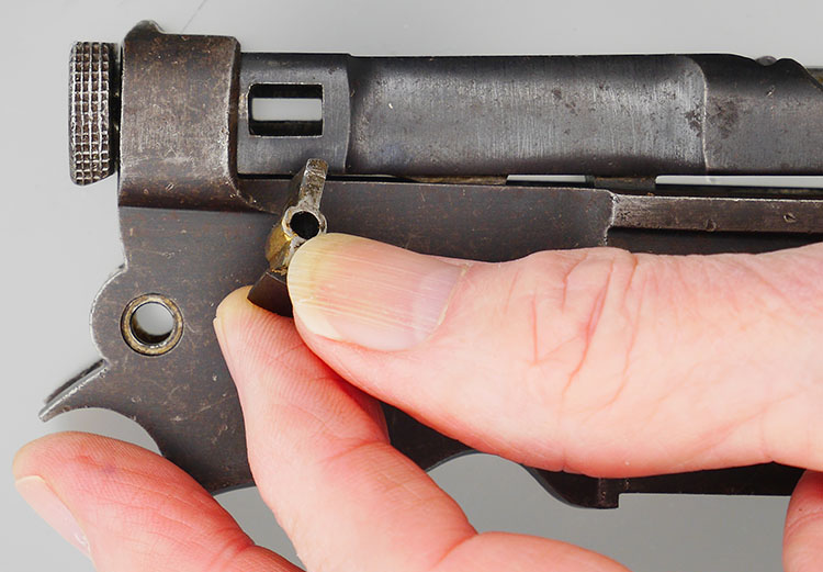 Retaining pin or transverse key that holds the bolt in the receiver.