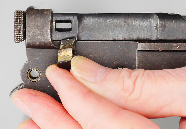 Retaining pin or transverse key that holds the bolt in the receiver.