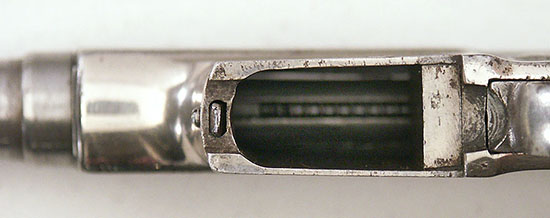 Spacer in rear of magazine well in .25 ACP conversion.
